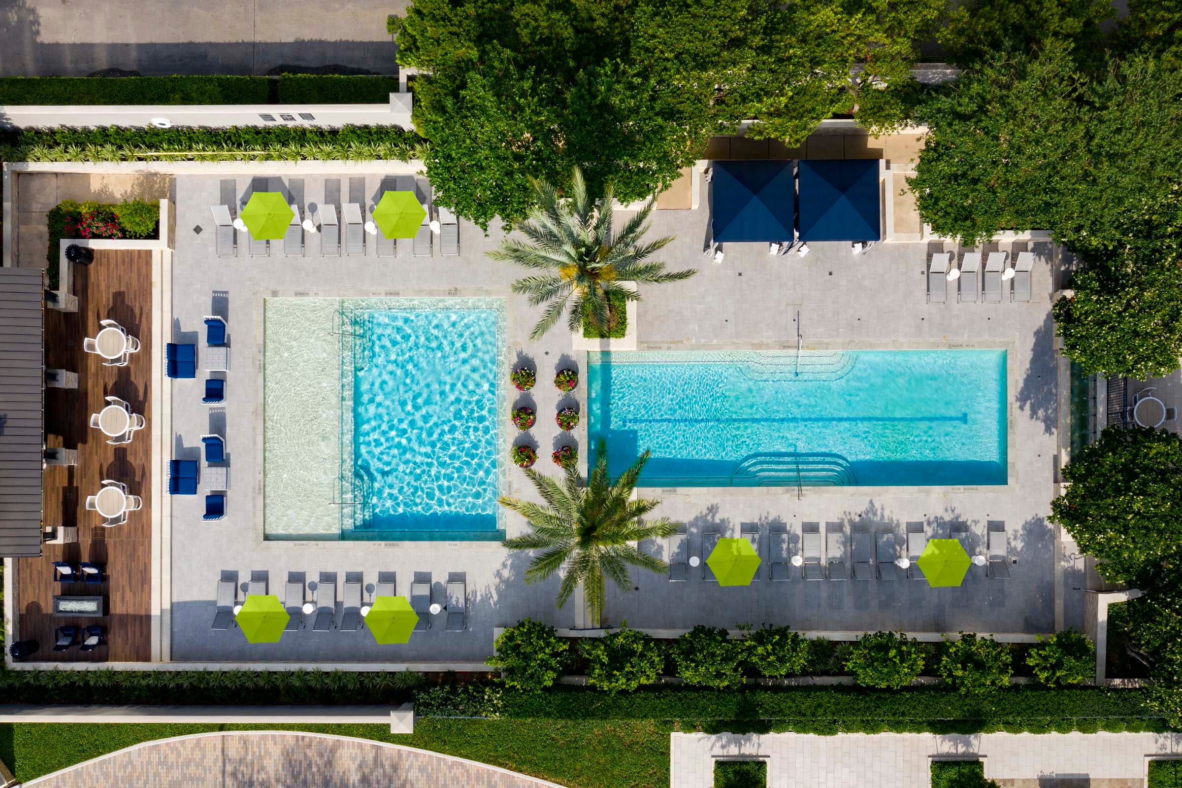 Resort-Style Swimming Pool with Cabanas and Outdoor Dining Area